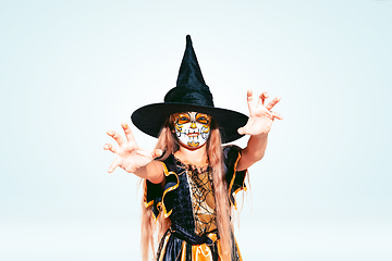 Image showing Little girl like a witch on white background