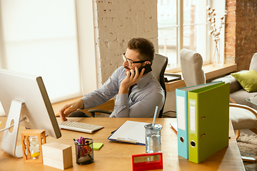 Image showing A young businessman moving in office, getting new work place