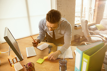 Image showing A young businessman moving in office, getting new work place