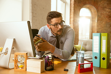 Image showing A young businessman moving in office, getting new work place