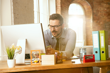 Image showing A young businessman moving in office, getting new work place