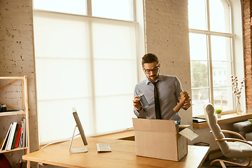 Image showing A young businessman moving in office, getting new work place