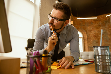 Image showing A young businessman moving in office, getting new work place