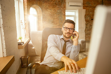 Image showing A young businessman moving in office, getting new work place