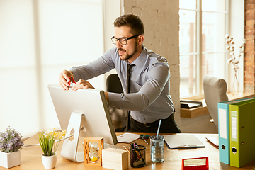 Image showing A young businessman moving in office, getting new work place