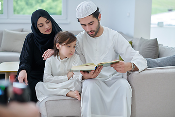 Image showing Young muslim family reading Quran during Ramadan