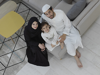 Image showing Top view of young arabian muslim family wearing traditional clothes