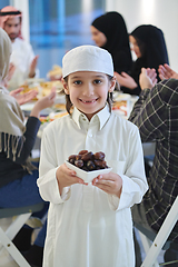 Image showing Arabian kid in the traditional clothes during iftar