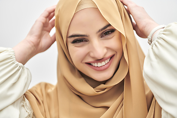 Image showing Portrait of young muslim woman wearing hijab on isolated white background