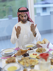 Image showing Muslim man making iftar dua to break fasting during Ramadan