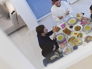 Image showing Top view of Muslim family making iftar dua to break fasting during Ramadan