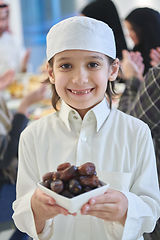 Image showing Arabian kid in the traditional clothes during iftar