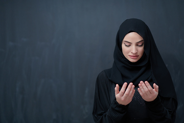 Image showing Portrait of young Muslim woman making dua