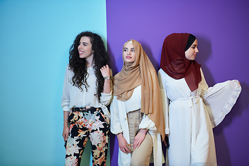 Image showing Young muslim women posing on purple and blue background