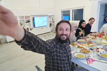 Image showing Muslim family taking selfie while having iftar together during Ramadan