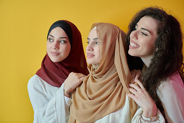 Image showing Young muslim women posing on yellow background