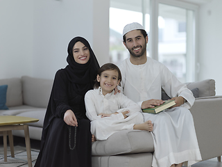 Image showing Young muslim family reading Quran during Ramadan