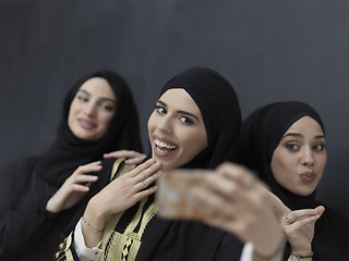 Image showing Portrait of Arab women wearing traditional clothes or abaya taking selfie