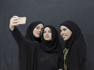 Image showing Portrait of Arab women wearing traditional clothes or abaya taking selfie