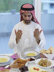 Image showing Muslim man making iftar dua to break fasting during Ramadan