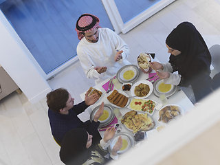 Image showing Top view of Muslim family making iftar dua to break fasting during Ramadan