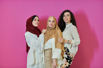 Image showing Young muslim women posing on pink background