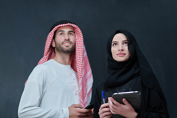 Image showing Young muslim business couple using technology devices