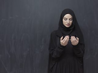 Image showing Portrait of young Muslim woman making dua