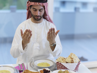 Image showing Muslim man making iftar dua to break fasting during Ramadan