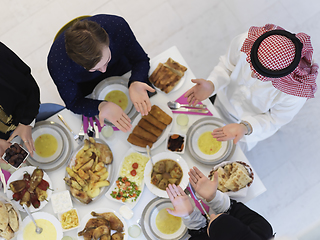 Image showing Top view of Muslim family making iftar dua to break fasting during Ramadan