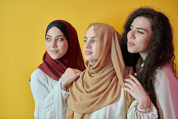 Image showing Young muslim women posing on yellow background