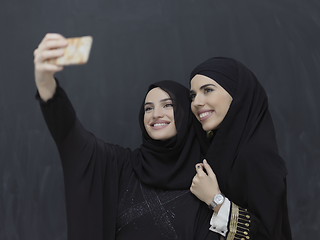 Image showing Portrait of Arab women wearing traditional clothes or abaya taking selfie