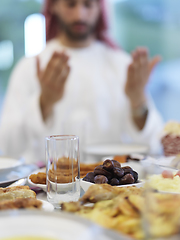 Image showing Muslim man making iftar dua to break fasting during Ramadan