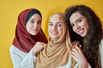 Image showing Young muslim women posing on yellow background