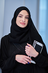 Image showing Young Arab businesswoman in traditional clothes or abaya with tablet computer