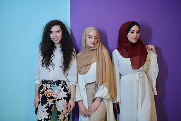 Image showing Young muslim women posing on purple and blue background