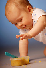 Image showing Baby playing with a food