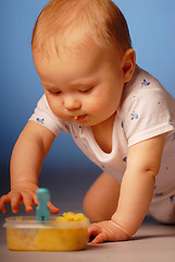 Image showing Baby playing with a food