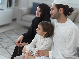 Image showing Top view of young arabian muslim family wearing traditional clothes