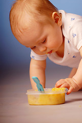 Image showing Baby playing with a food