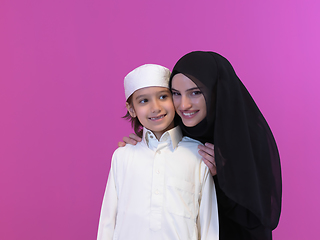 Image showing young arabian mother and son wearing traditional clothes