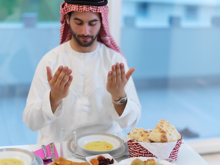 Image showing Muslim man making iftar dua to break fasting during Ramadan