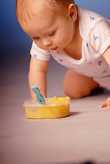 Image showing Baby playing with a food