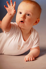 Image showing Little boy examining his hand