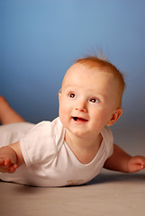 Image showing A smiling little boy on a floor