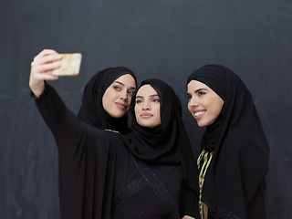 Image showing Portrait of Arab women wearing traditional clothes or abaya taking selfie