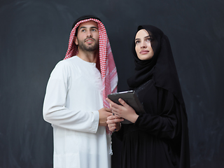 Image showing Young muslim business couple using technology devices