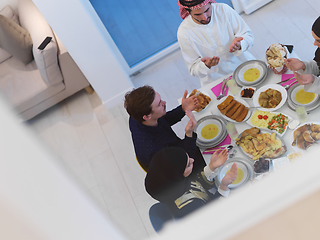 Image showing Top view of Muslim family making iftar dua to break fasting during Ramadan