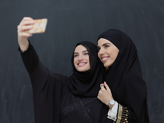Image showing Portrait of Arab women wearing traditional clothes or abaya taking selfie