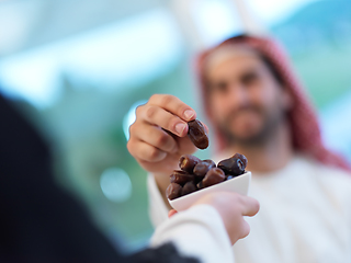 Image showing Muslim couple sharing dates for starting iftar